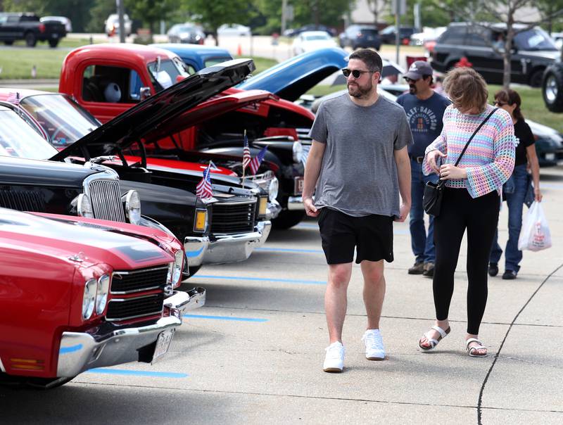 Visitors check out some of the cars Saturday, June 14, 2025, at the Flag Day Car Show in the Hy-Vee parking lot in Sycamore.